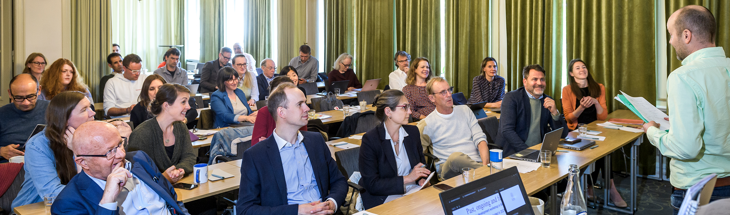 Photo of people gathered in a conference room.
