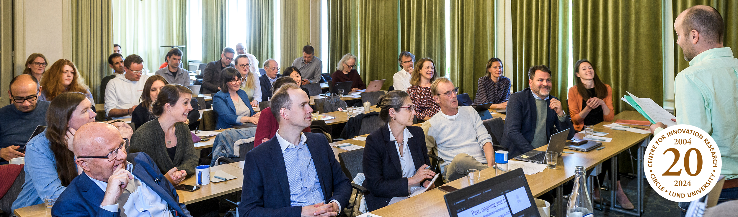 Photo of people gathered in a conference room.