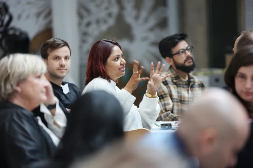 People seated together. Photo.